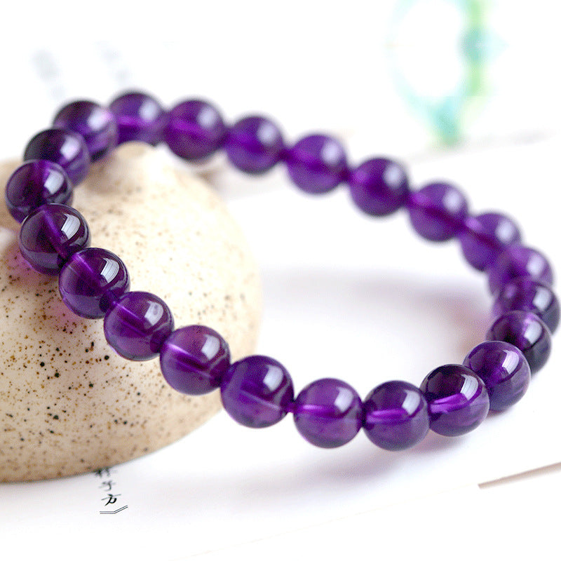 Purple beaded bracelet on a white background