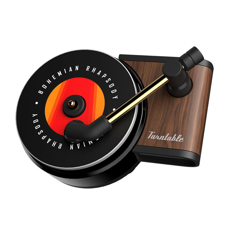 Turntable with wooden finish and 'Bohemian Rhapsody' vinyl on a white background