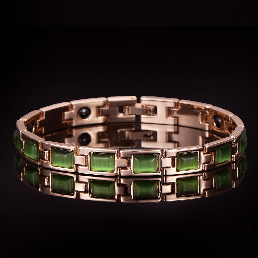 Bracelet with green gemstones and rose gold accents on a black background