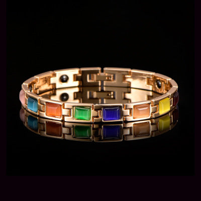 Multicolored bracelet with a metallic band on a black background