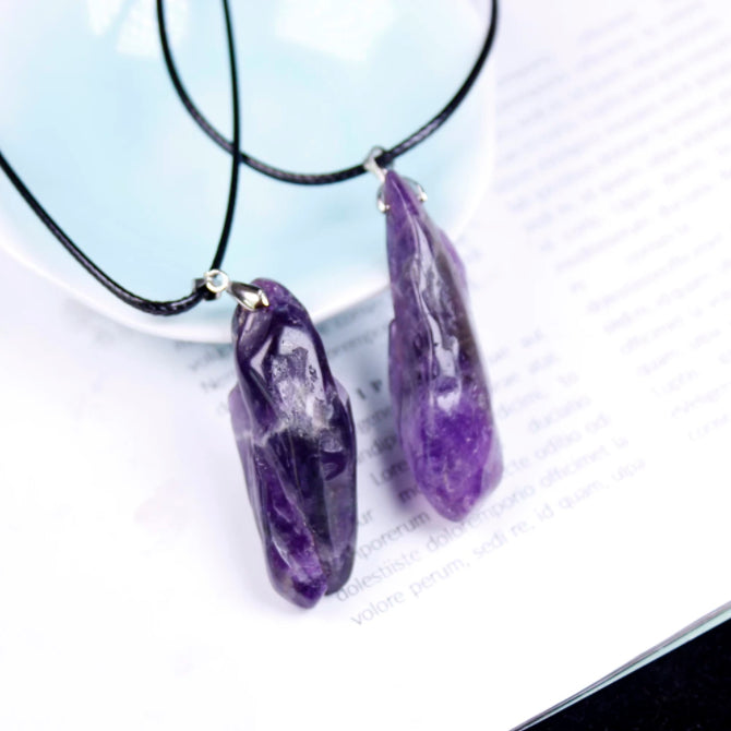 Purple crystal pendant necklace on a light background