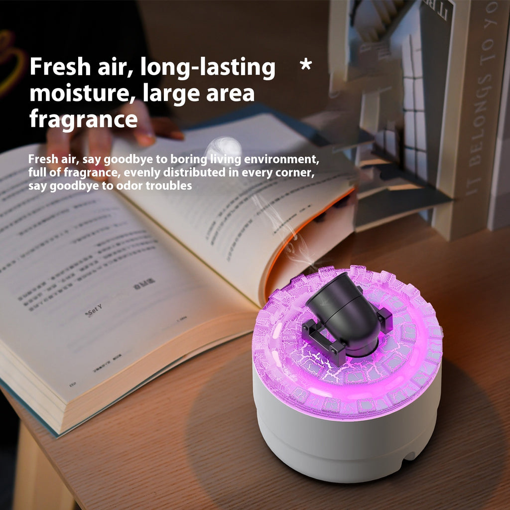 Small fragrance diffuser with pink light on a wooden surface next to an open book.