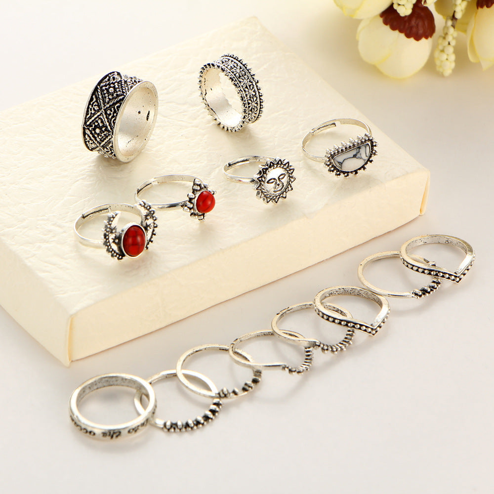 Collection of silver rings with gemstones on a white surface