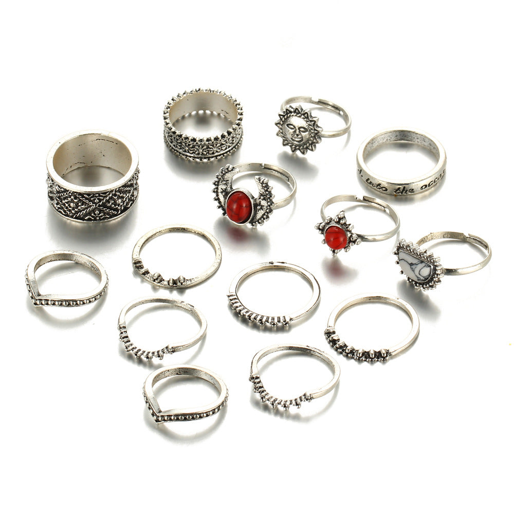 Collection of silver rings with various designs on a white background