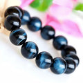 Blue tiger eye beaded bracelet on a white background
