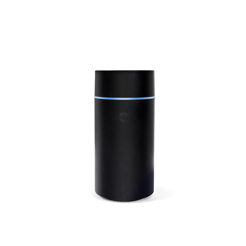 Black cylindrical device with a blue light on a white background