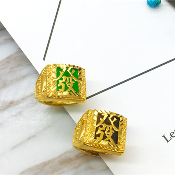Gold and green decorative items on a marble surface