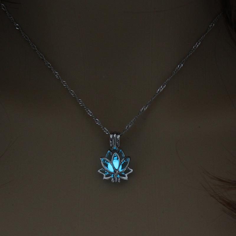 Necklace with a blue lotus flower pendant on a dark background