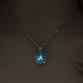 Necklace with a blue lotus flower pendant on a dark background