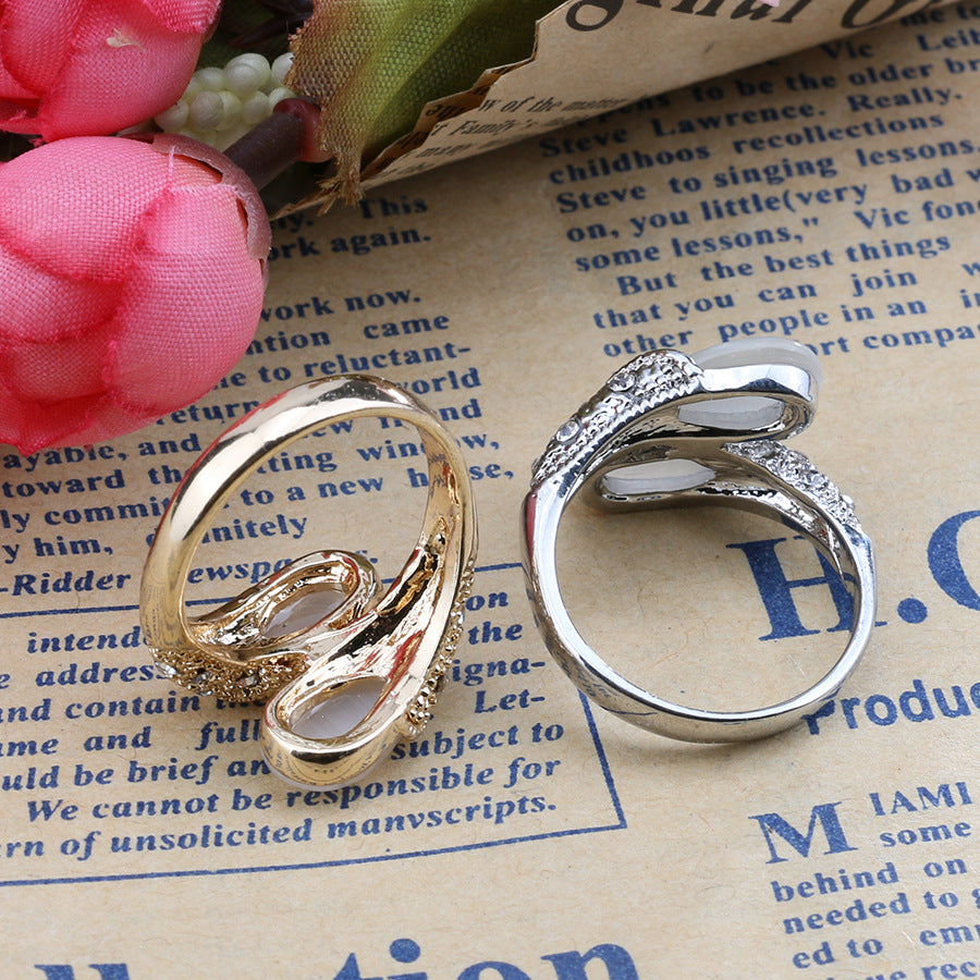 Two gold and silver rings on a piece of paper with text.