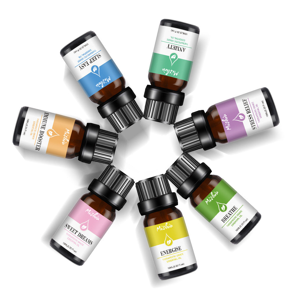 Assorted small bottles with colorful labels arranged in a circle on a white background
