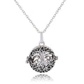 Silver tree of life pendant on a chain against a white background