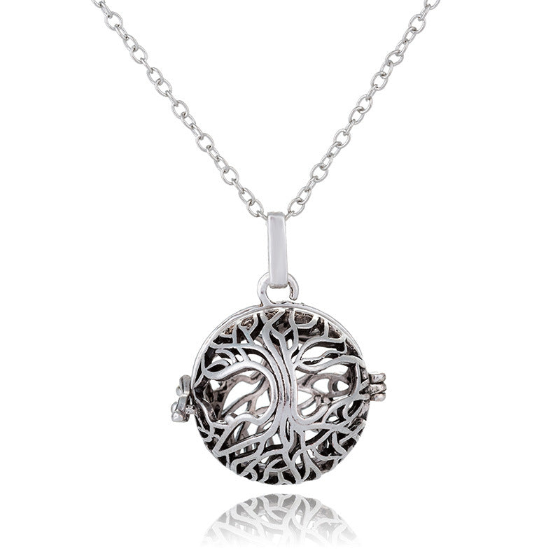 Silver tree of life pendant on a chain against a white background