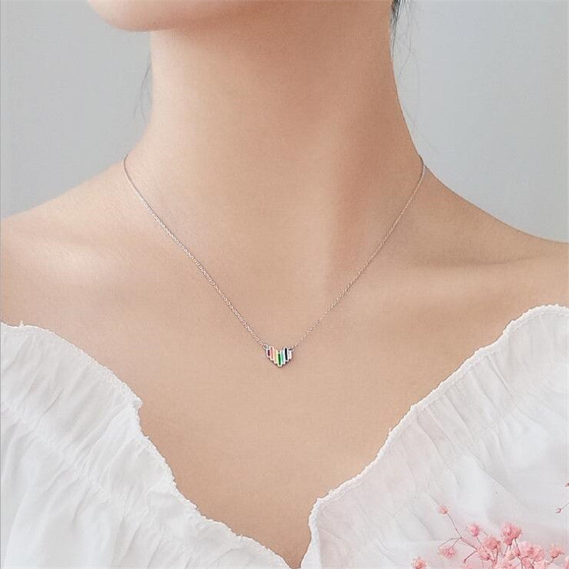 Necklace with a colorful pendant on a mannequin against a neutral background