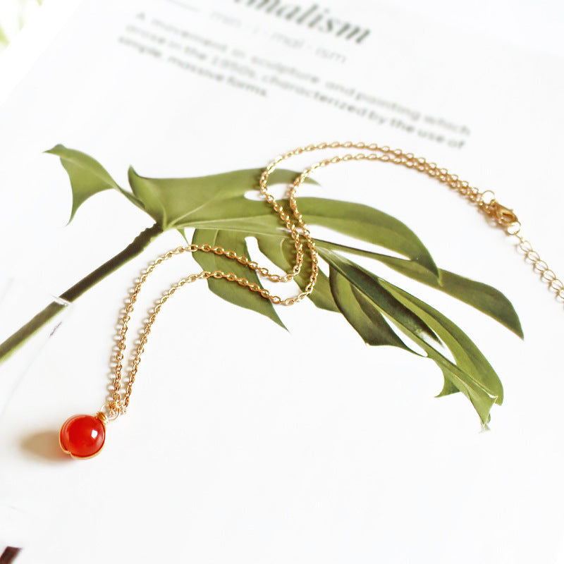 Necklace with a red pendant on a white background