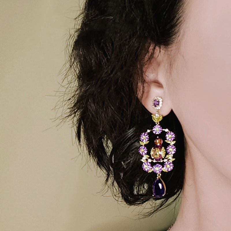 Close-up of an ear wearing a colorful earring with a blurred background