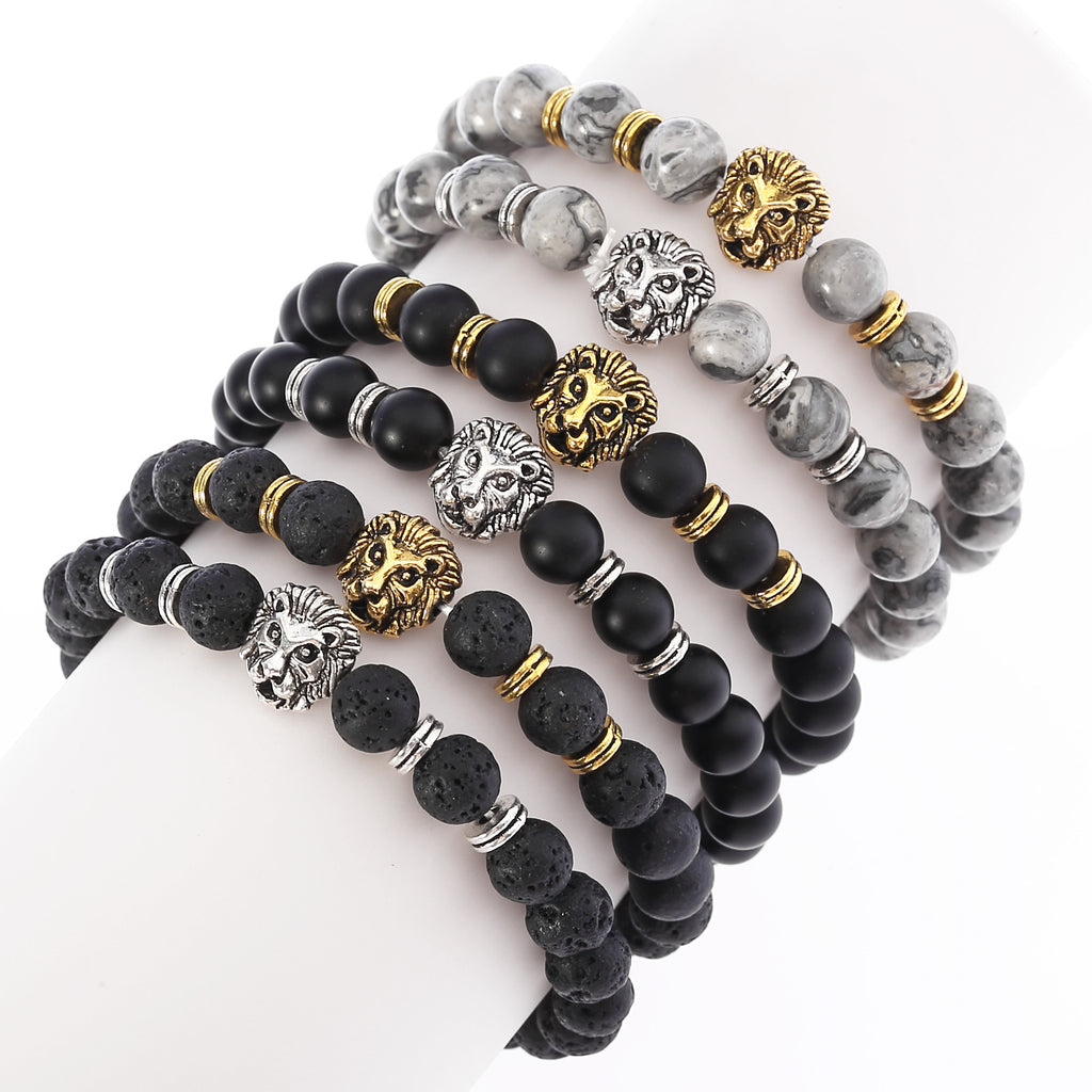 Set of beaded bracelets with lion head charms on a white background