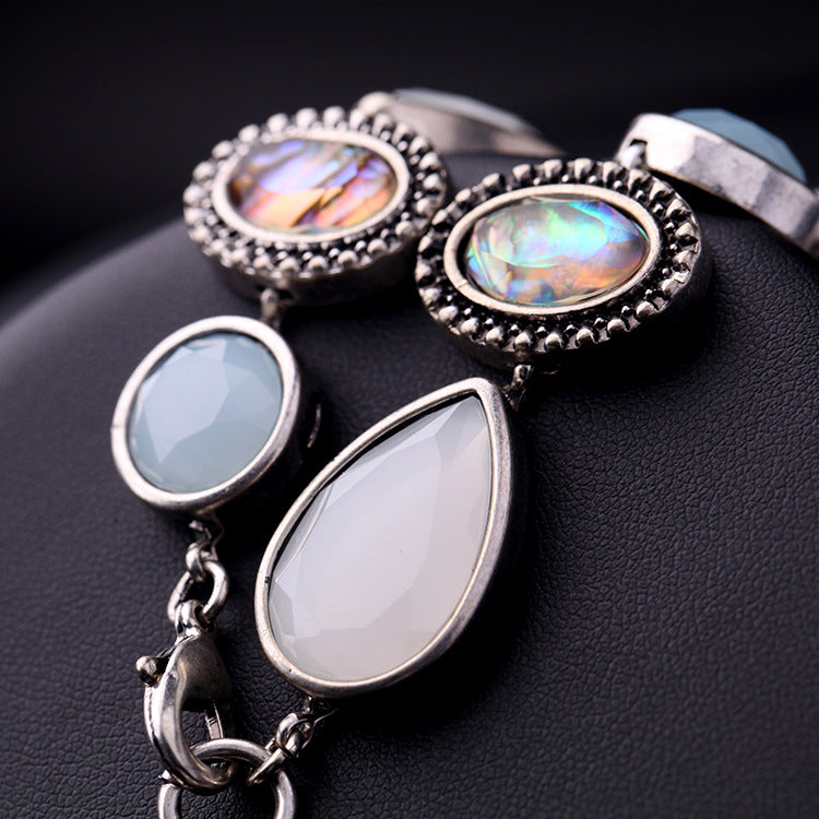Jewelry set with opal stones on a dark background