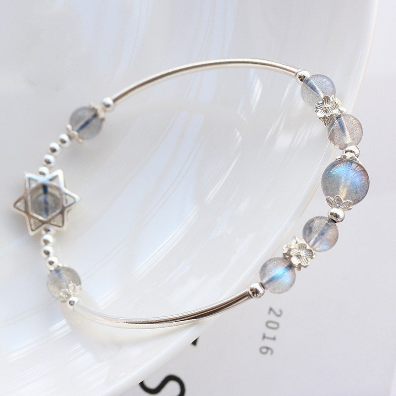 Silver bracelet with beads on a white background