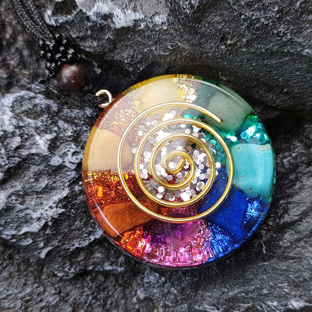 Colorful spiral pendant on a dark stone surface