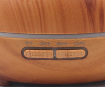 Wooden diffuser with control buttons on a blurred background