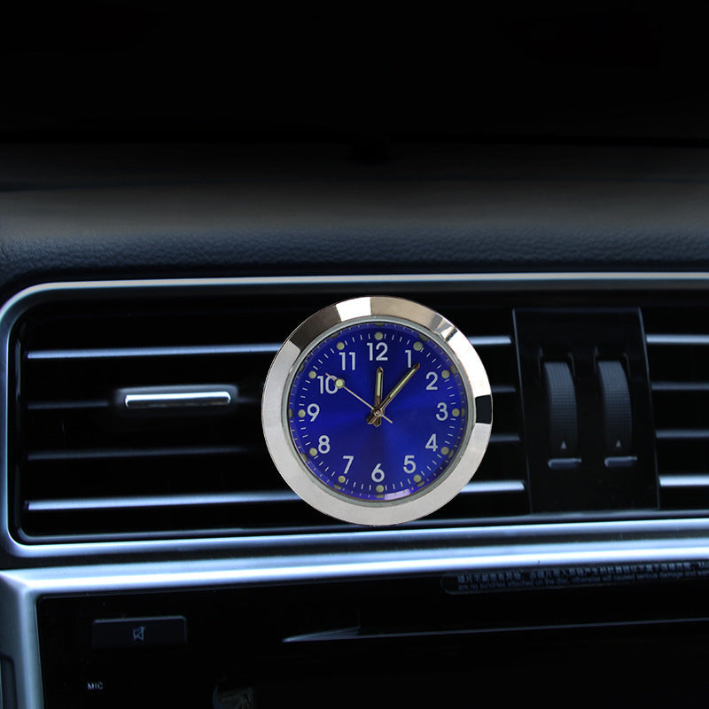 Blue clock with silver frame on a car dashboard