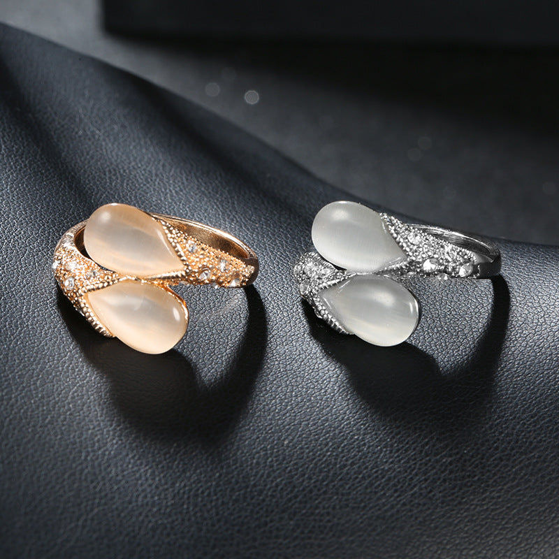 Two rings with stone accents on a dark textured surface