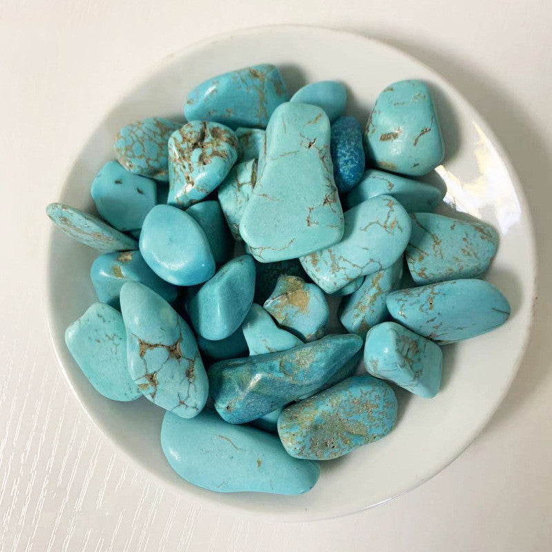 Turquoise stones on a white plate