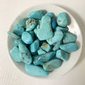 Turquoise stones on a white plate