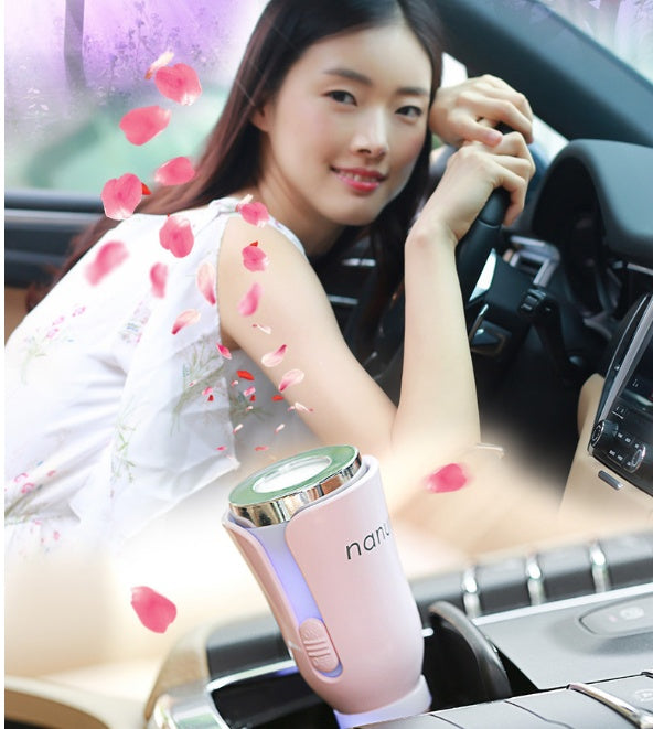 Woman sitting in a car with a pink and green device, surrounded by rose petals.