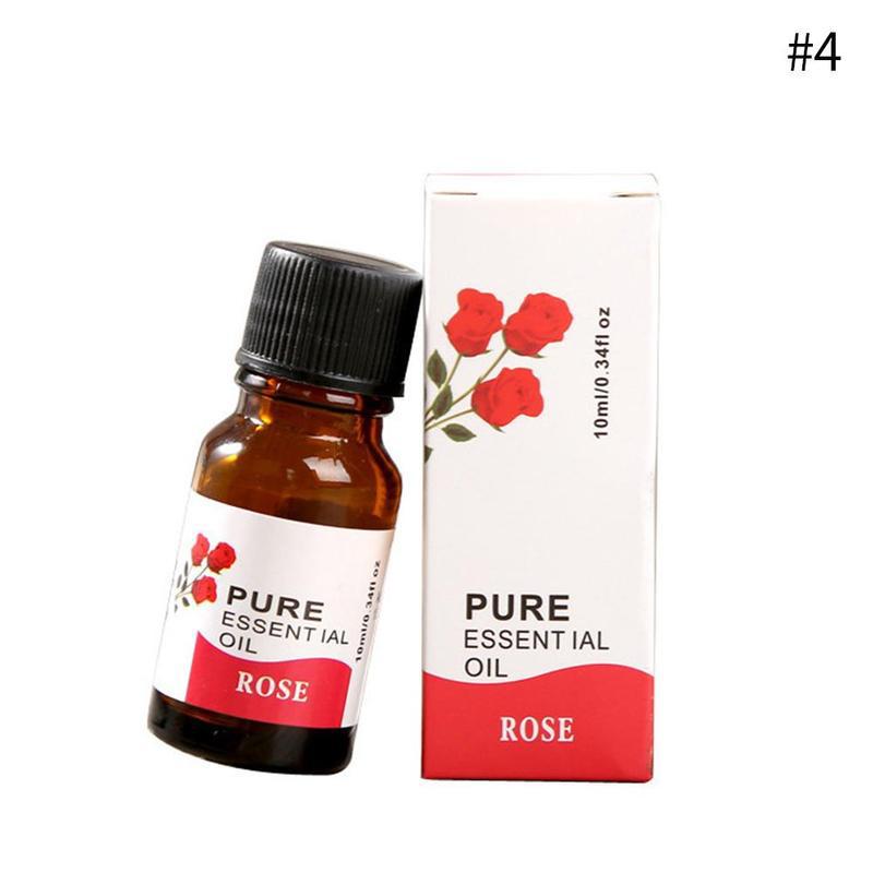 Bottle and box of pure essential oil with rose design on a white background