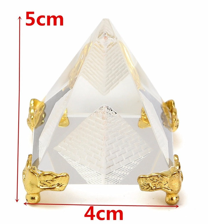 Pyramid-shaped object with gold accents and measurements on a white background