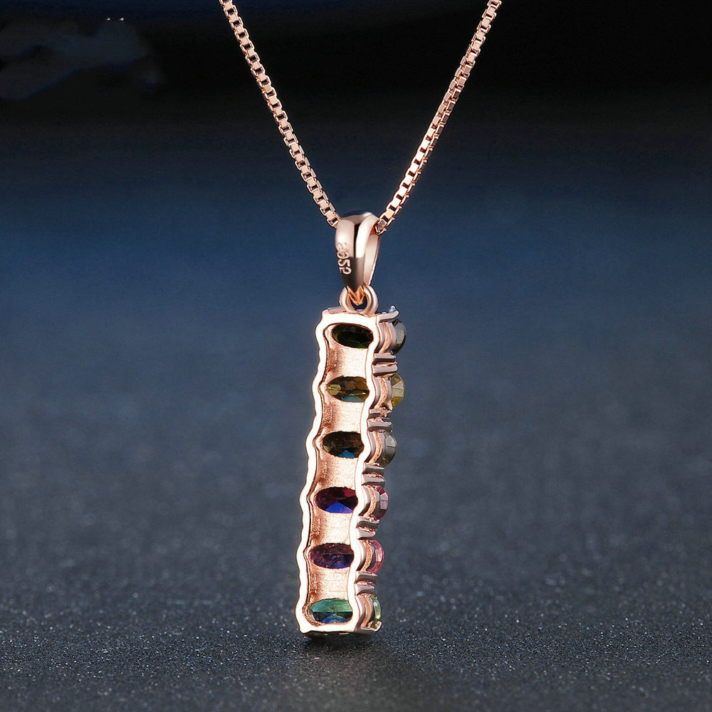 Rose gold necklace with a unique pendant on a dark background