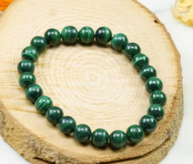 Green beaded bracelet on a wooden surface