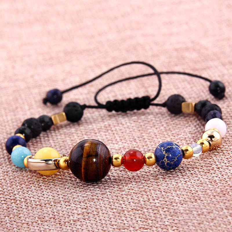 Multicolored beaded bracelet on a pink fabric background