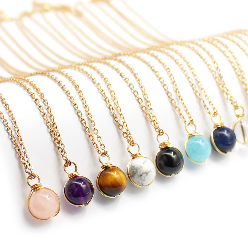 Gold necklaces with various colored gemstones on a white background