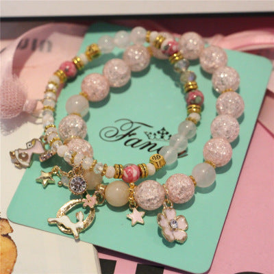 Set of beaded bracelets with charms on a green card with 'Fanc' branding.