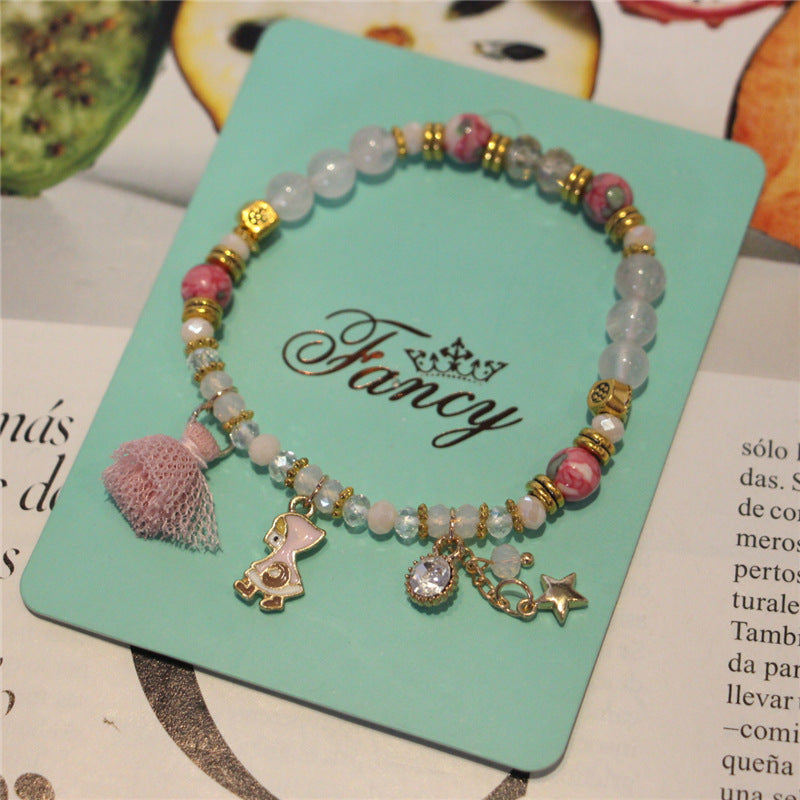 Colorful beaded bracelet with charms on a 'Fancy' branded card