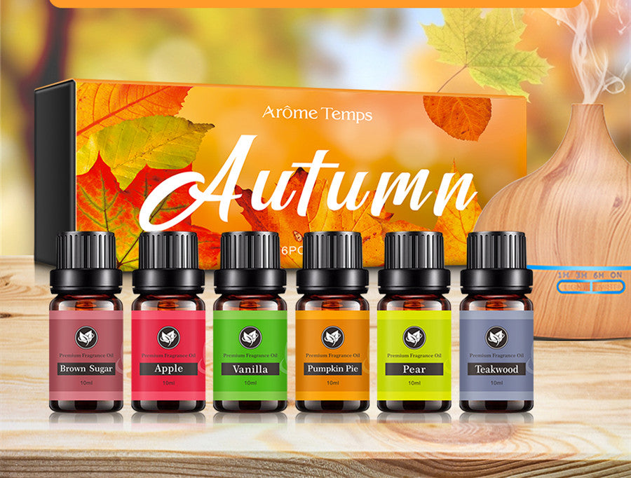 Set of autumn-themed essential oil bottles with a decorative box in the background.