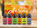 Set of autumn-themed essential oil bottles with a decorative box in the background.