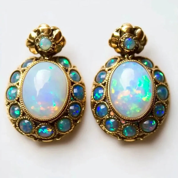 Pair of opal earrings with gold accents on a white background