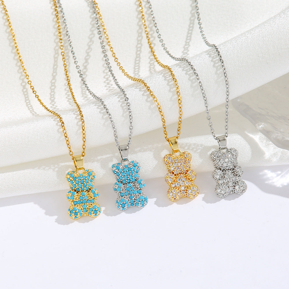 Four bear-shaped pendants on chains with different color options on a white background
