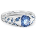 Silver ring with blue gemstone on a white background