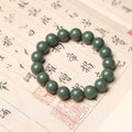 Green beaded bracelet on a piece of paper with Chinese characters