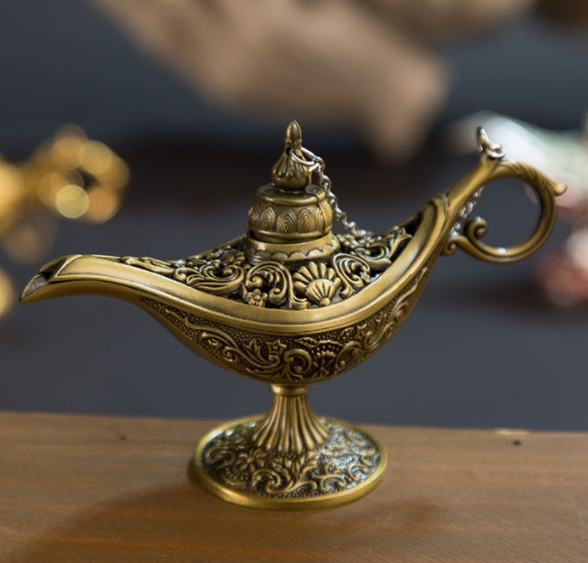 Decorative gold lamp on a wooden surface with a blurred background