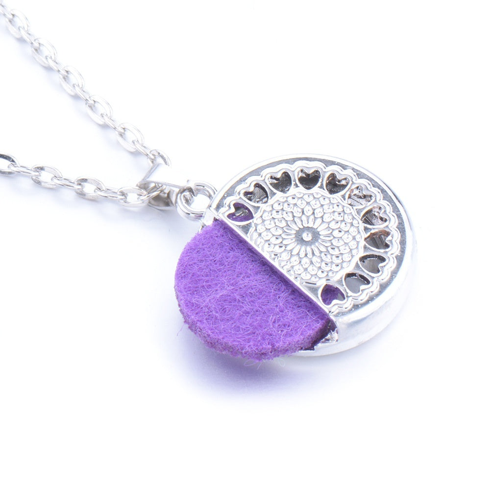 Necklace with a purple half-circle pendant and silver heart pattern on a white background