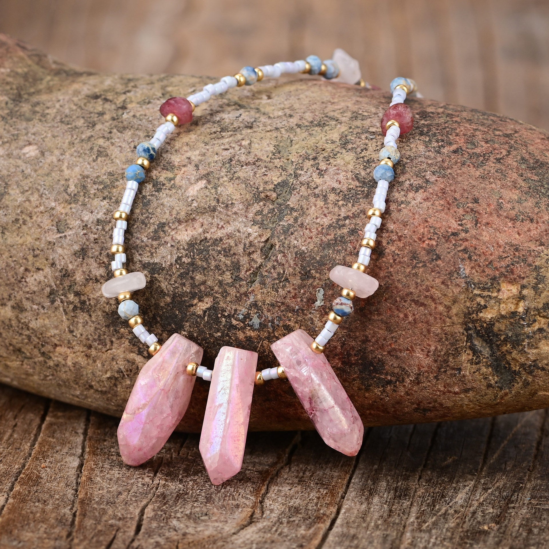 Necklace with pink stones and small beads on a wooden surface