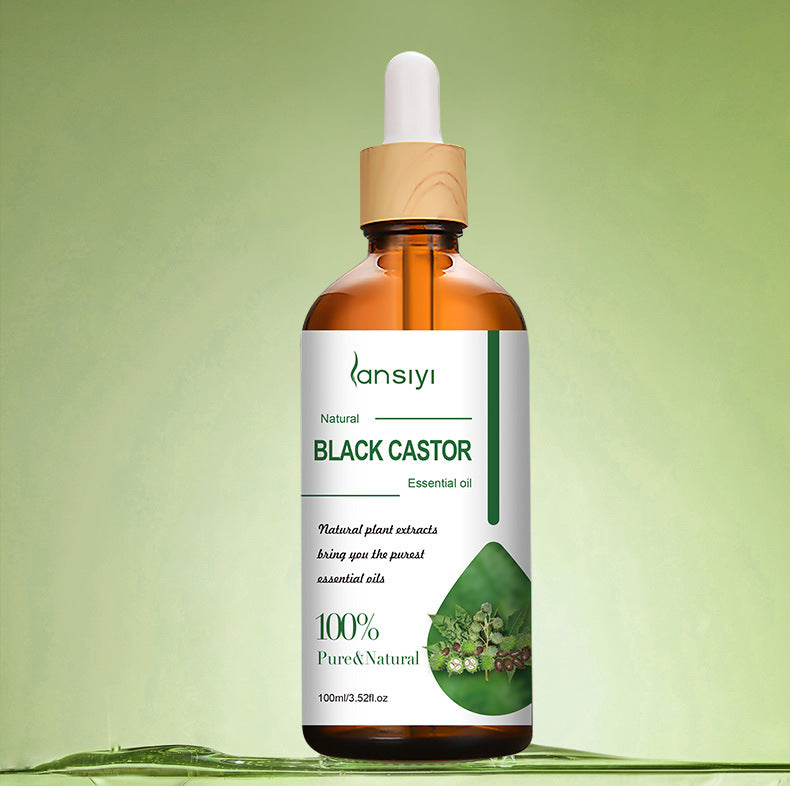 Bottle of Black Castor essential oil with a dropper on a green background