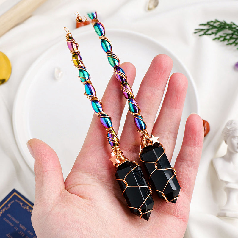 Colorful beaded earrings held in a hand with a white background