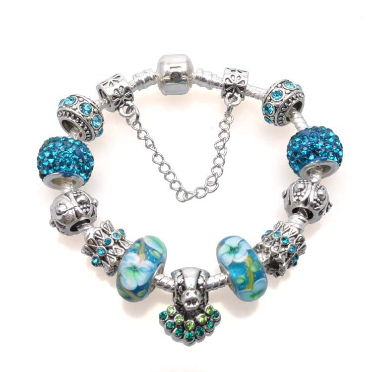 Bracelet with blue and silver charms on a white background